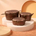 Antique copper containers on podiums.webp