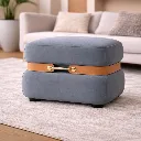 Stylish grey ottoman with leather accents.webp