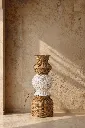 Woven vase in sunlit interior.webp