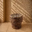 Sunlit wicker basket in woven corner.webp