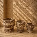 Sunlit woven baskets on textured floor (1).webp