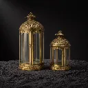 Antique brass lanterns on black sand.webp