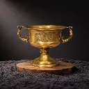 Antique gold urn on dark sand.webp