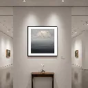Serene gallery with misty mountain artwork.webp