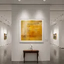 Minimalist art gallery with golden abstract painting.webp
