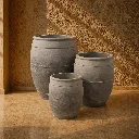 Sunlit stone pots on rustic stone floor.webp