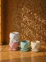 Pastel ceramics in sunlit still life.webp