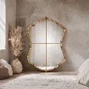 Elegant gold mirror in cozy room.webp