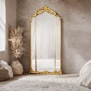 Elegant gold-framed mirror in serene room (1).webp