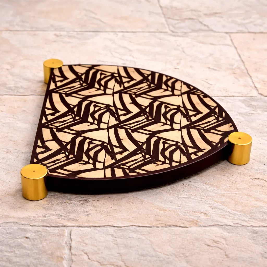 Elegant Art Deco trivet on stone floor.webp