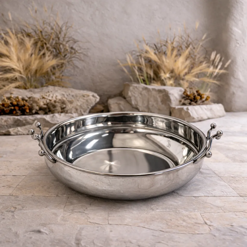 Polished serving dish on stone floor.webp