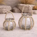 Beaded glass lanterns on stone patio.webp